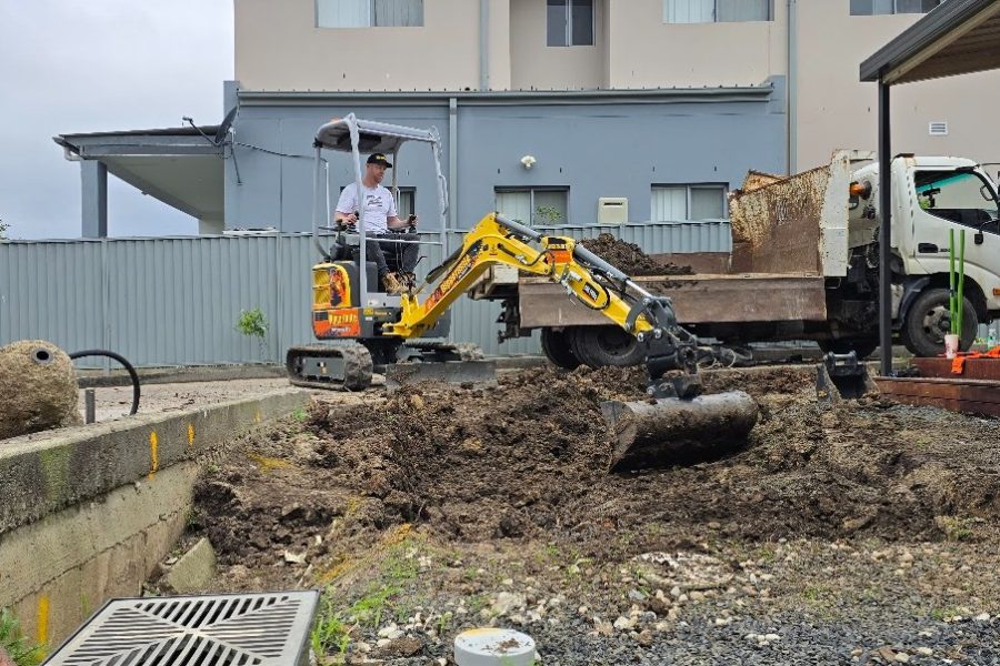 Mini excavator digging and levelling for a slab area